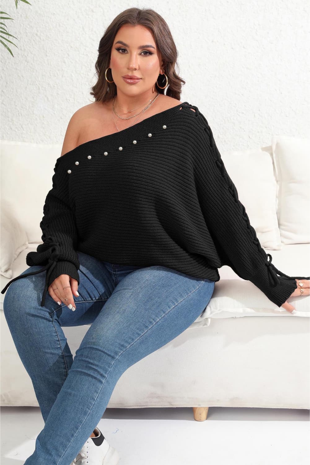 Model front view wearing Plus Size One Shoulder Beaded Sweater in the color black