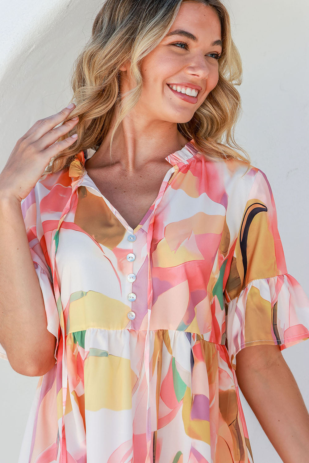 Close up view of flounce sleeve mini dress.