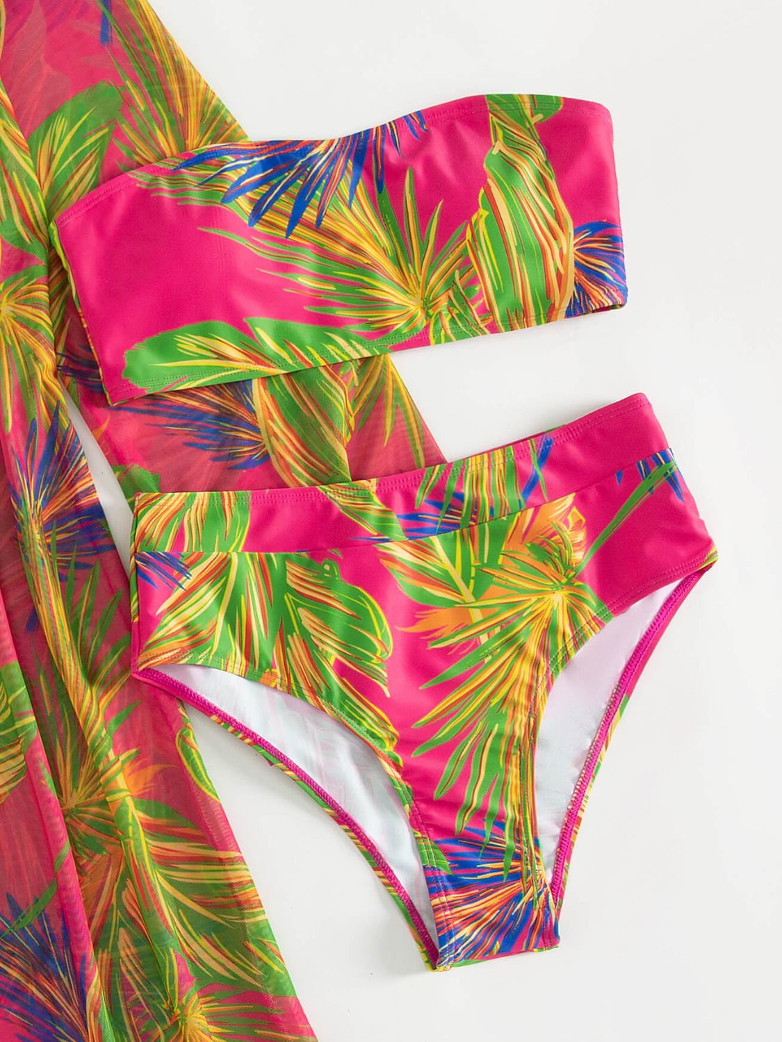 Close-up of The Exclusive Emerald's botanical print tube top and swim bottoms, highlighting the vibrant pattern and summer-ready style.